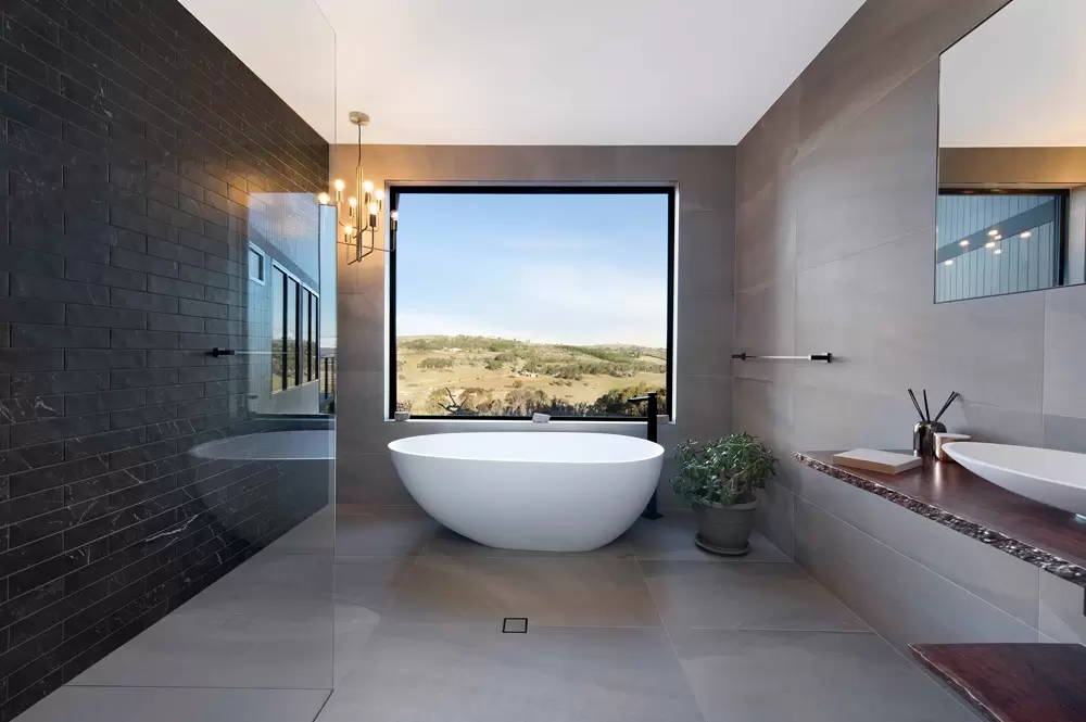 Architectural bathroom with a picture window looking over regional Australian farmland
