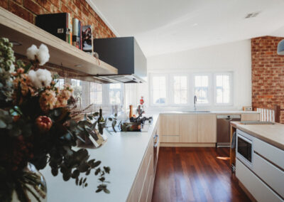 New kitchen in Canberra. White benchtops against kitchen wall and timber on the island.