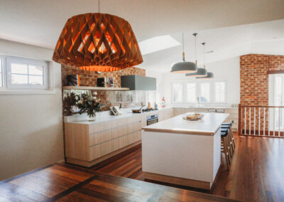 Pendant in foreground, kitchen in background. Skylights in ceiling.