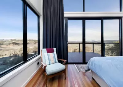 Inside the Master Bedroom with windows looking over landscape.