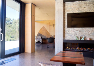 View from entry through to dining room. Fireplace separates the two spaces.