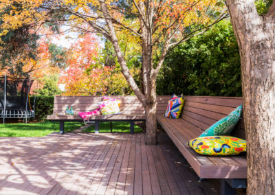 Architectural garden deck with Canberra trees and a built-in timber bench