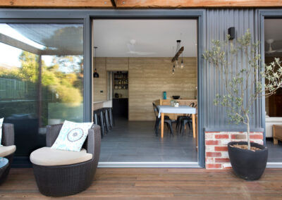 Indoor/Outdoor living areas showing deck and colourbond/brick walls.